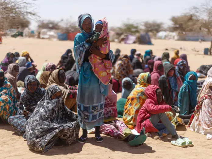 Sudanese refugees wait to be given aid.