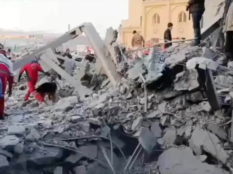 Members of the Iranian Red Crescent Society work at the site of a reported strike amid the U.S.-Israeli conflict with Iran, near a Mosque in Zanjan, Iran