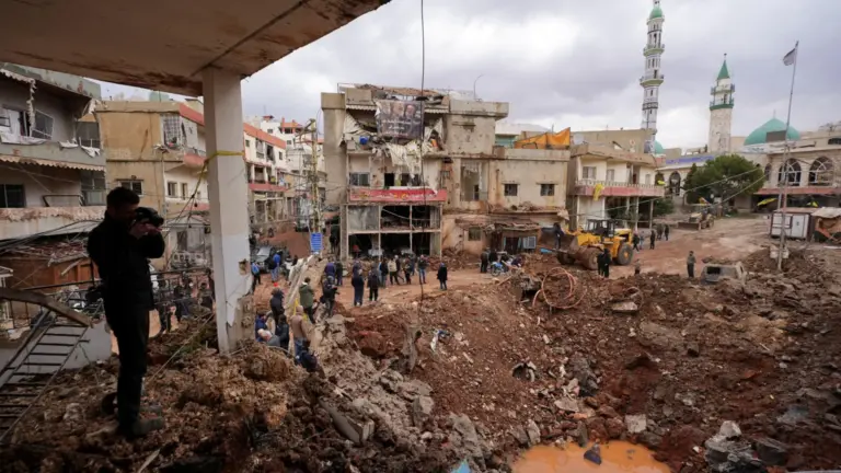 Reuters People inspect the damage where Israel's military carried out an airborne operation that dropped troops overnight, in the town of Nabi Chit.