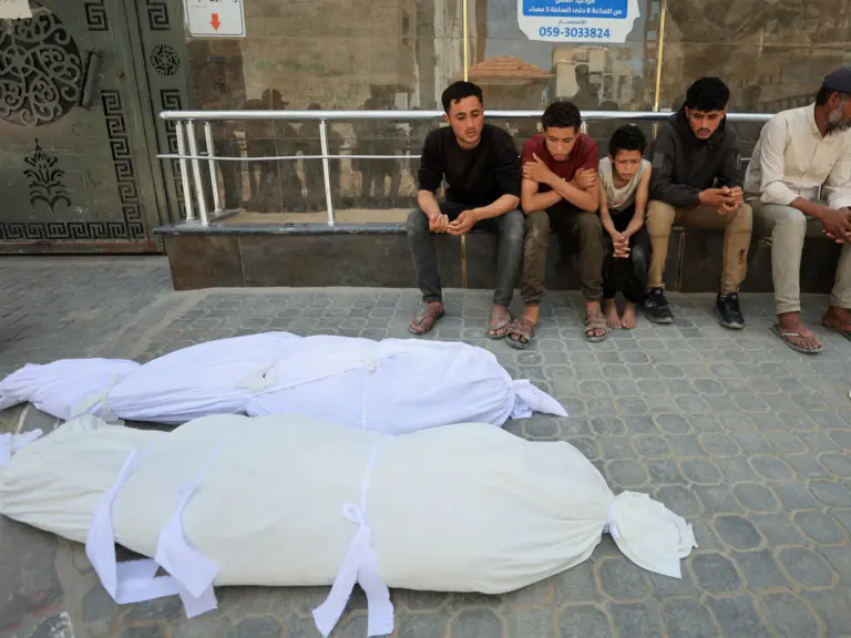 People mourn next to the bodies of Palestinian brothers Abdel Malek and Abdel Sattar Al-Attar killed in Gaza