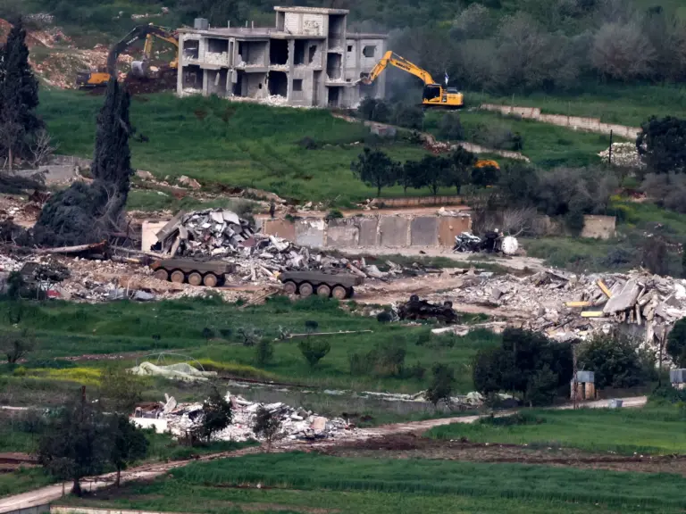 Israeli army armoured vehicles and excavators demolishing houses in the southern Lebanese village of Mais al-Jabal