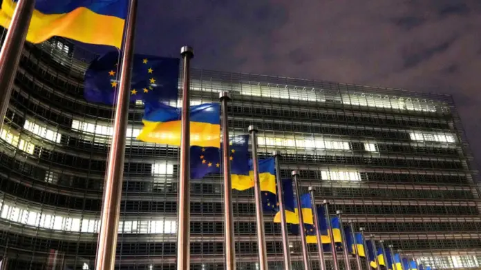 The European Union and Ukrainian flags flap in the wind