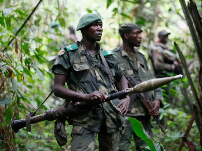 DRC soldiers carrying weapons in a forest whilst patrol against ADF rebels near Beni in North-Kivu province