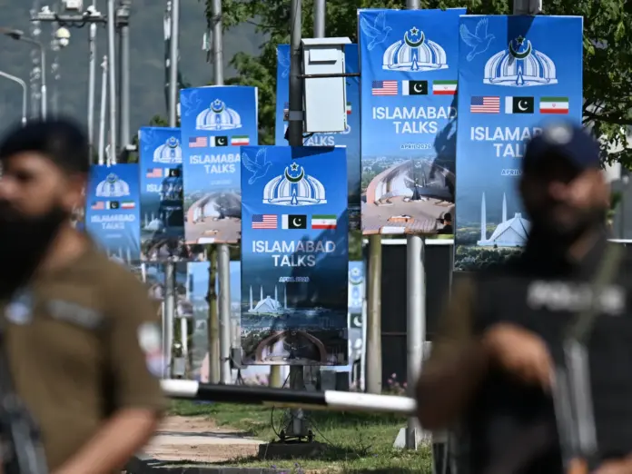 TOPSHOT - Security personnel stand guard at a security checkpost along a road temporarily closed near the Serena Hotel at the Red Zone area in Islamabad on April 20, 2026, ahead of anticipated US-Iran peace talks.