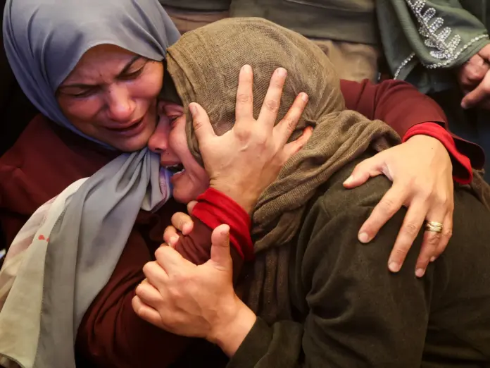 Sister and wife of Khamees Al-Qassas, killed on Tuesday in an Israeli airstrike, according to medics, react during his funeral at Nasser Hospital in Khan Younis in the southern Gaza Strip, April 21, 2026. REUTERS/Ramadan Abed