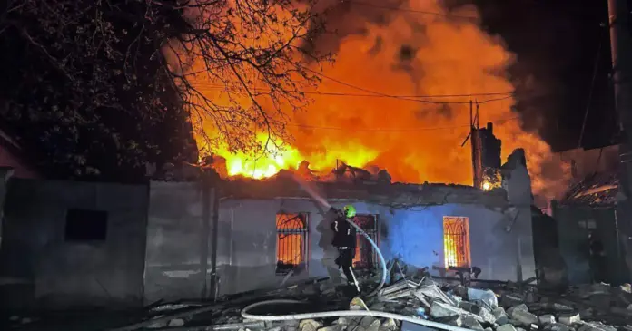 A rescue worker puts out a fire.