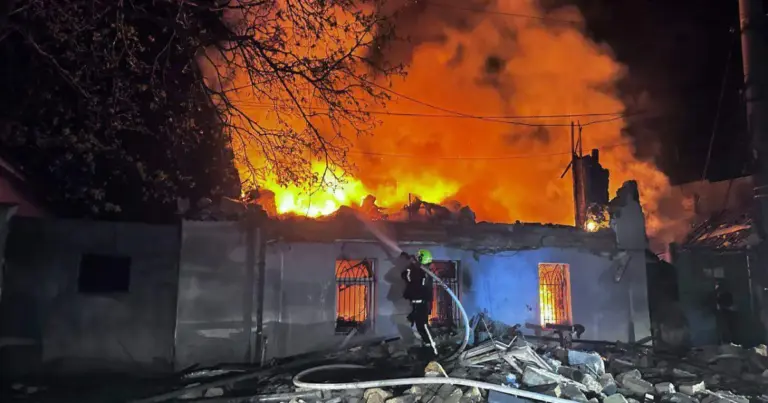 A rescue worker puts out a fire.