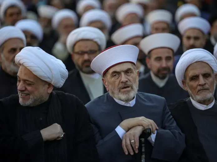 People attend a gathering to pay tribute to Iran’s supreme leaders.