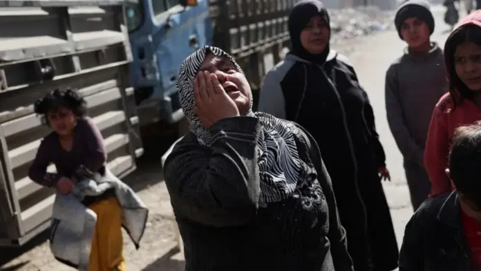 Reuters A woman holds her hand to her face in grief in the district of Tadamon in Damascus (file photo)