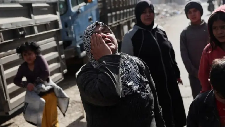 Reuters A woman holds her hand to her face in grief in the district of Tadamon in Damascus (file photo)