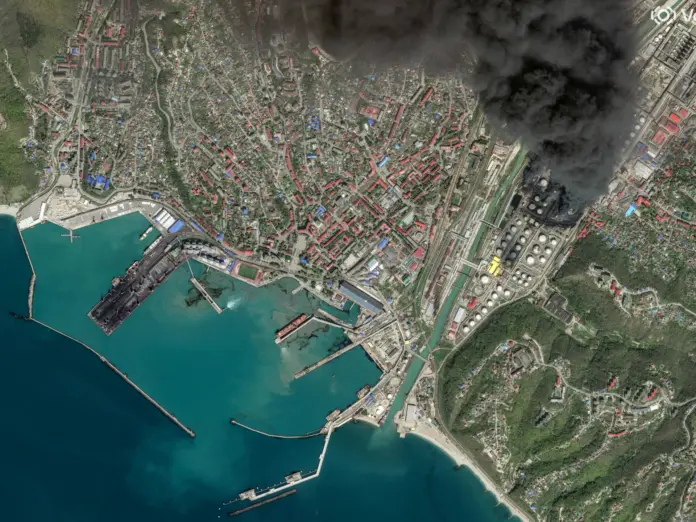 A satellite image shows an oil spill in a sea.
