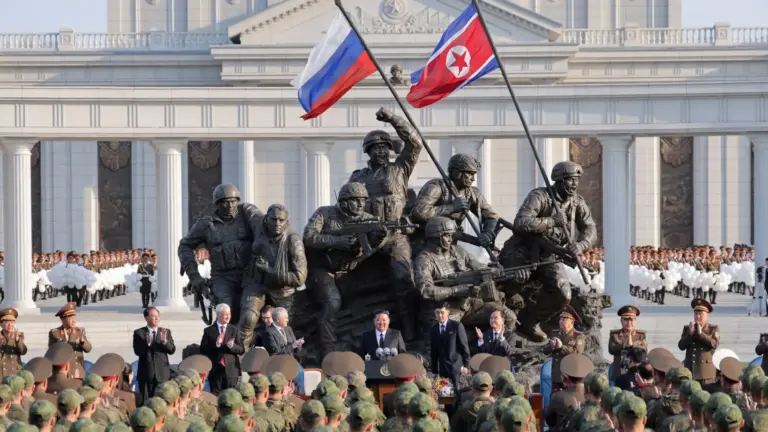 KCNA via Reuters Wide shot showing North Korean leader Kim Jong Un speaking to soldiers wearing military uniforms as he stands on a monument in Pyongyang for Russian soldiers who died in the Ukraine war