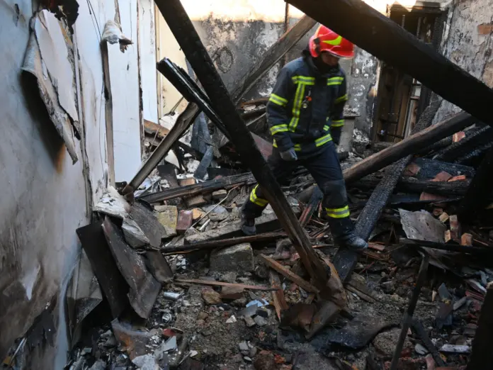 A rescue worker walks inside apartments destroyed by a Russian strike in Odesa, Ukraine, Monday, April 27, 2026. (AP Photo/Michael Shtekel)