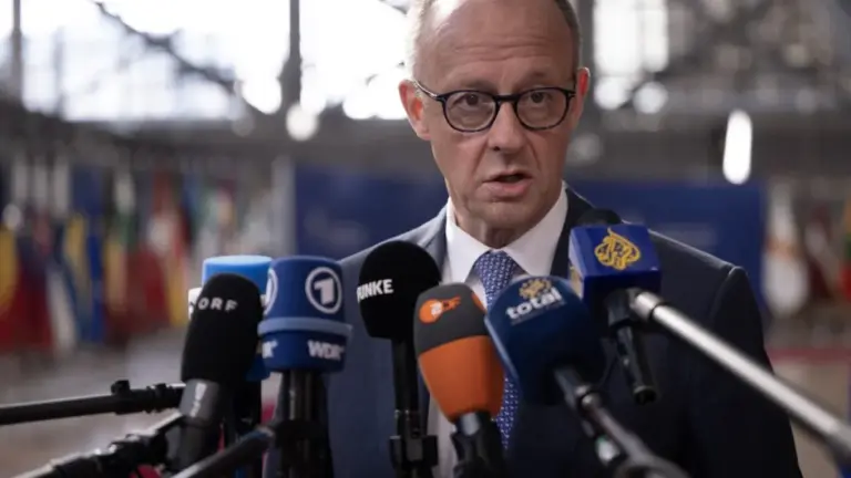 Germany's Chancellor Friedrich Merz speaks to journalists as he arrives for a EU Summit at the EU headquarters in Brussels, on March 19, 2026. European Union leaders meet in the context of the US-Israeli war against Iran that is consuming the Middle East, and its consequences on energy prices and security. (Photo by JOHN THYS / AFP)