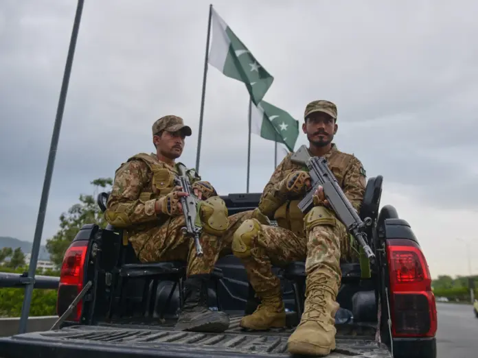 Army soldiers take positions in an overhead bridge to ensure security in Islamabad, Pakistan, Friday, April 24, 2026. (AP Photo/M.A. Sheikh)