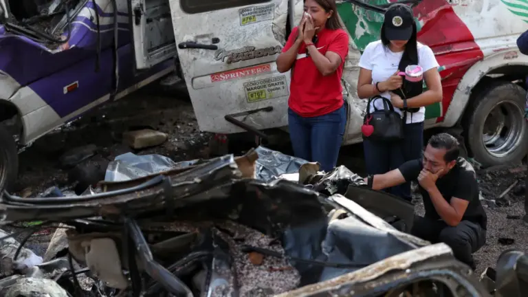Relatives of victims pay respects at the site of an attack.