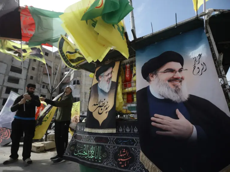 TOPSHOT - An image of slain Hezbollah leader Hassan Nasrallah, who was killed by Israel in 2024, is seen as Hezbollah supporters gather for a solidarity rally against the United States and Israel, in Beirut’s southern suburbs on April 25, 2026.