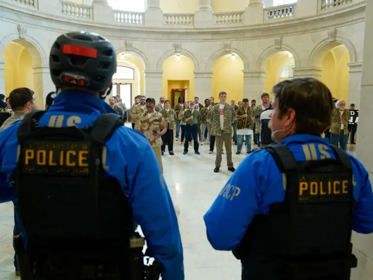 WASHINGTON, DC - APRIL 20: U.S. Capitol Police officers look on as veterans, military family members, and supporters occupy the Cannon House Office Building on Capitol Hill calling upon the Trump administration to end the war on Iran on April 20, 2026 in Washington, DC. Leigh Vogel/Getty Images for About Face: Veterans Against The War/AFP (Photo by Leigh Vogel / GETTY IMAGES NORTH AMERICA / Getty Images via AFP)
