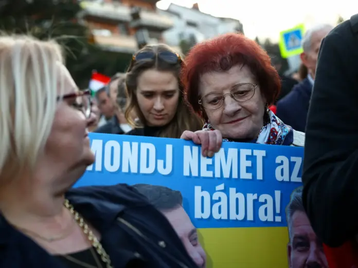 A woman holds a placard as people take part in a protest against what organisers call 