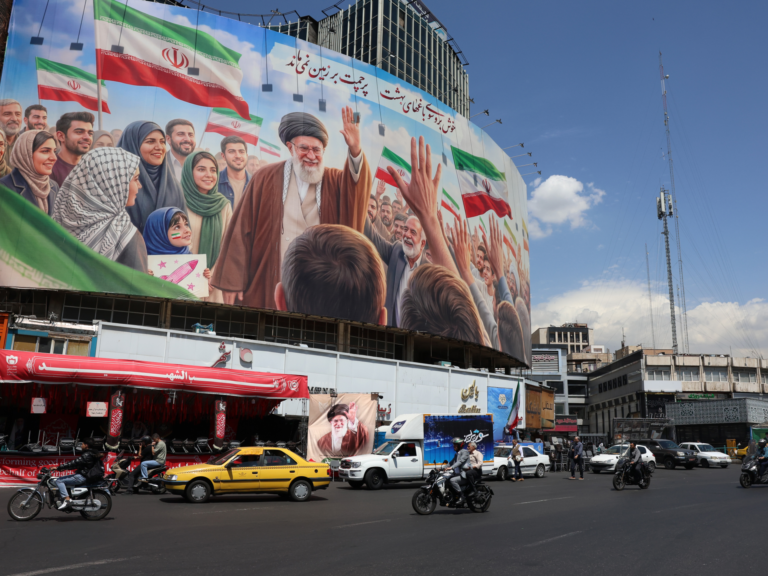 epa12918543 Iranians drive past a huge billboard carrying a picture of the late Iranian Supreme Leader Ayatollah Ali Khamenei in Tehran, Iran, 28 April 2026. US President Donald Trump announced that a ceasefire between the US and Iran has been extended. EPA/ABEDIN TAHERKENAREH