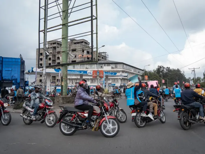 Activists hold signs denouncing the war during a march in Goma, North Kivu, DR Congo on March 12, 2026.
