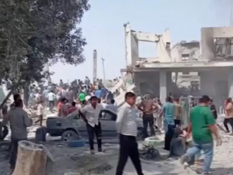 People gather at the site of a destroyed building at a school where several people were killed in a reported strike, amid the U.S.-Israeli conflict with Iran, in Minab, Iran in this screengrab obtained from a social media video released on February 28, 2026. Social Media/via Reuters TV/via REUTERS THIS IMAGE HAS BEEN SUPPLIED BY A THIRD PARTY. NO RESALES. NO ARCHIVES. NEWS USE ONLY. BEST QUALITY AVAILABLE. REFILE – REMOVING ATTRIBUTION TO STRIKE VERIFICATION: -Building, curb, road layout, wall,