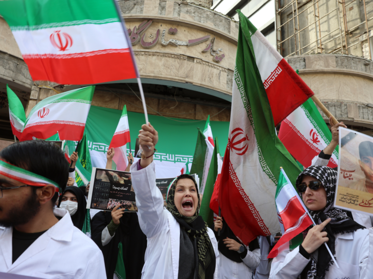 epa12801143 Members of Iranian medical personnel take part in a protest in front of the destroyed Gandhi Hospital by a US-Israel airstrike in Tehran, Iran, 07 March 2026. A joint US-Israeli military operation continued to target multiple locations across Iran, marking the eighth day of the conflict that began on 28 February. EPA/ABEDIN TAHERKENAREH