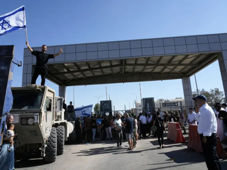A protester waves the Israeli flag in support of the soldiers accused of abuse, outside the Sde Teiman detention centre in July 2024