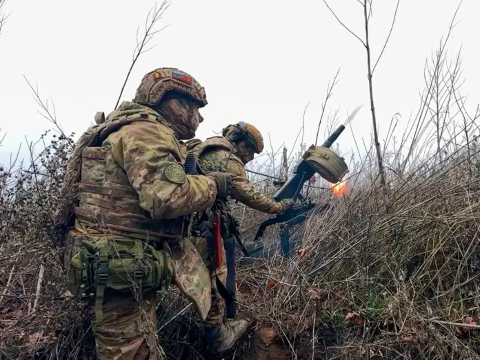 In this image made from video provided by Russian Defense Ministry Press Service on Tuesday, March 31, 2026, Russian soldiers fire a grenade launcher towards Ukrainian positions on an undisclosed location in Ukraine. (Russian Defense Ministry Press Service via AP)