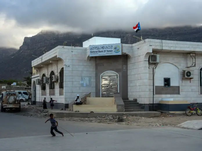 SOCOTRA ISLAND, YEMEN - OCTOBER 16: A boy runs past a branch of the National bank of Yemen in the main town of Hadibu on October 16, 2025 in Socotra, Yemen. Socotra, the largest island in an eponymous archipelago, lies 150 miles off the Horn of Africa, and even farther from mainland Yemen. Its relative isolation has mitigated the impact of Yemen's long-running and stalemated civil war, rendering it safe enough to attract a small but steady stream of foreign tourists. However, it has not been unt