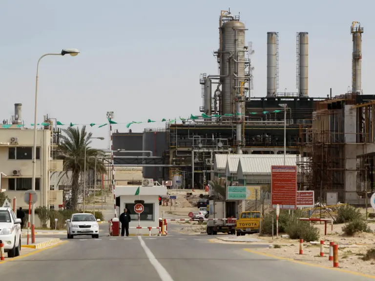 A security guard stands at at a gate inside the Zawiya Oil Refinery in Zawiya, west of Tripoli, Libya Thursday, March 3, 2011. Libya, which sits on the most reserves in Africa and is a major exporter to Europe, continues to produce oil, though experts say it's unclear how much will eventually make it to international ports. (AP Photo/Ben Curtis)